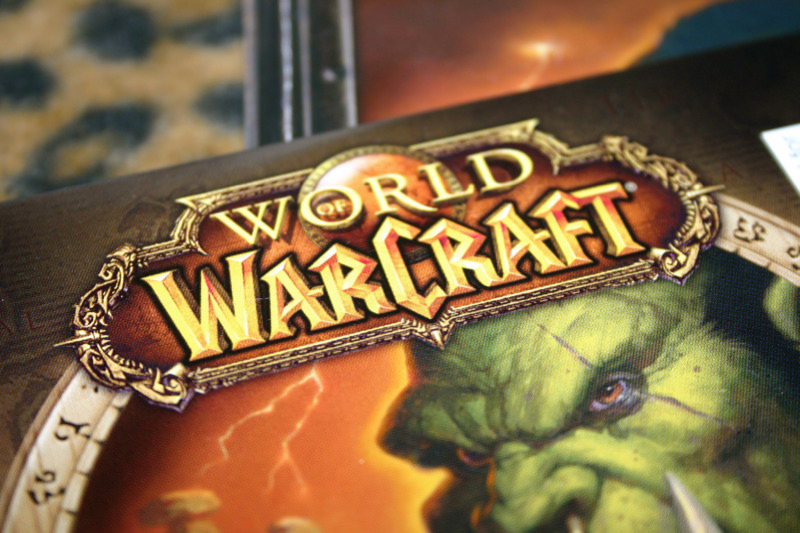The cover of the video game World of Warcraft, including a green, fanged ogre, is shown here.
