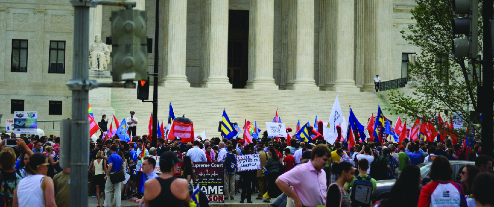 An image of a group of people at the steps of the Supreme Court building. Many people are holding flags marked with the symbol of an equals sign.