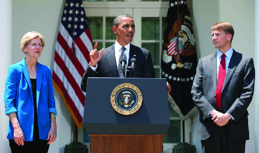 A photo of President Barack Obama speaking at a podium with Elizabeth Warren to his left and Richard Cordray to his right.