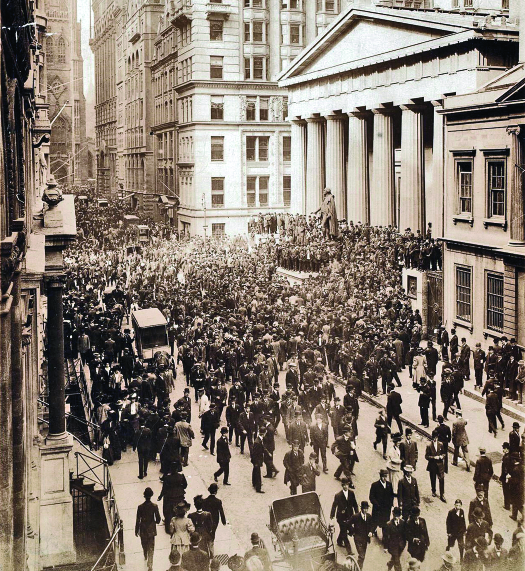 An image of a large crowd of people filling Wall Street.