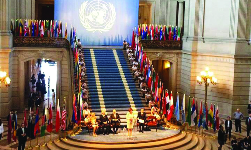 An image of Nancy Pelosi and several dignitaries at the United Nations Charter.