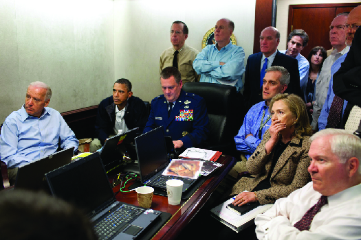 An image of Barack Obama, Joe Biden, Hillary Clinton, Robert Gates, and other national security advisors in the White House Situation Room.